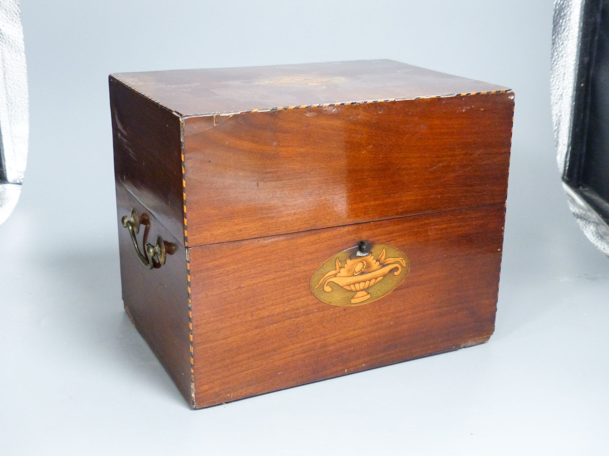 A mahogany inlaid decanter box containing five gilt decorated decanters